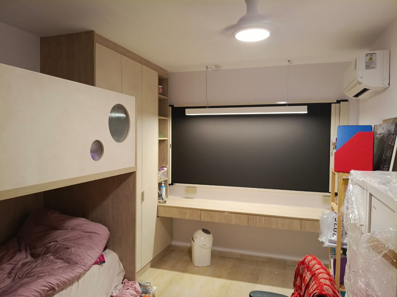 BlindXpert 2-in-1 insect screen and blind installed in a Singapore bedroom with the blind layer closed