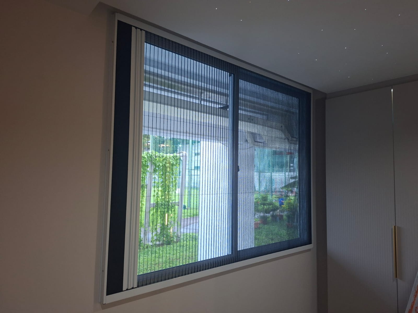 Standard folding mosquito screen installed across a window