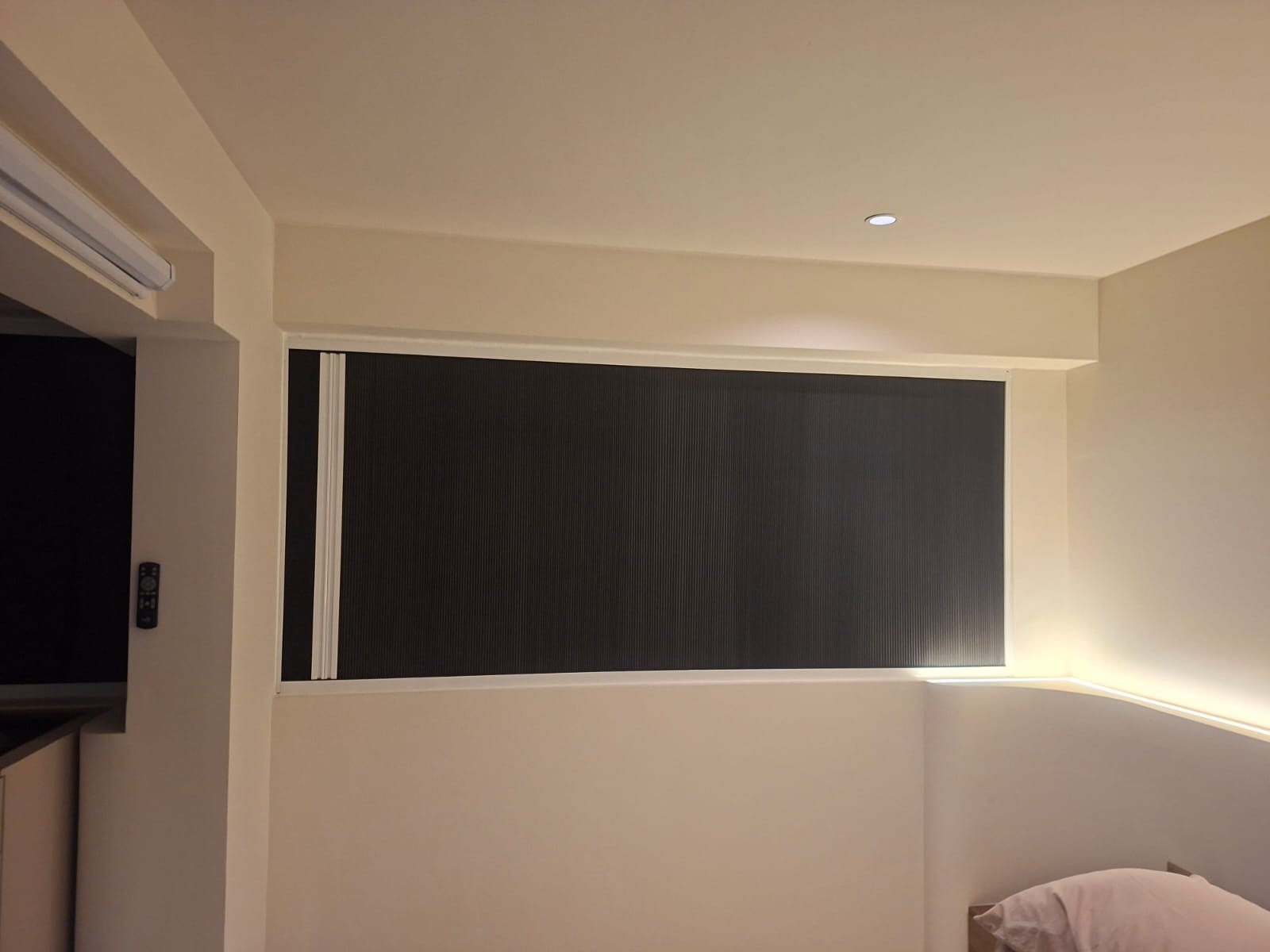 Dark sunshade fully closed across a residential window